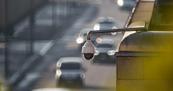 LPR camera mounted on a pole at a parking facility entrance capturing license plates